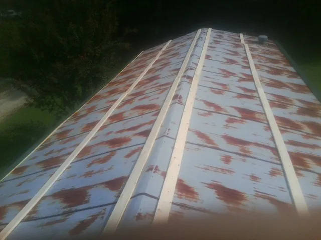 Rusted metal roof panels with new wood purlins before replacement — Storm Damage Roof Repair in Pasco by Roofing Brothers